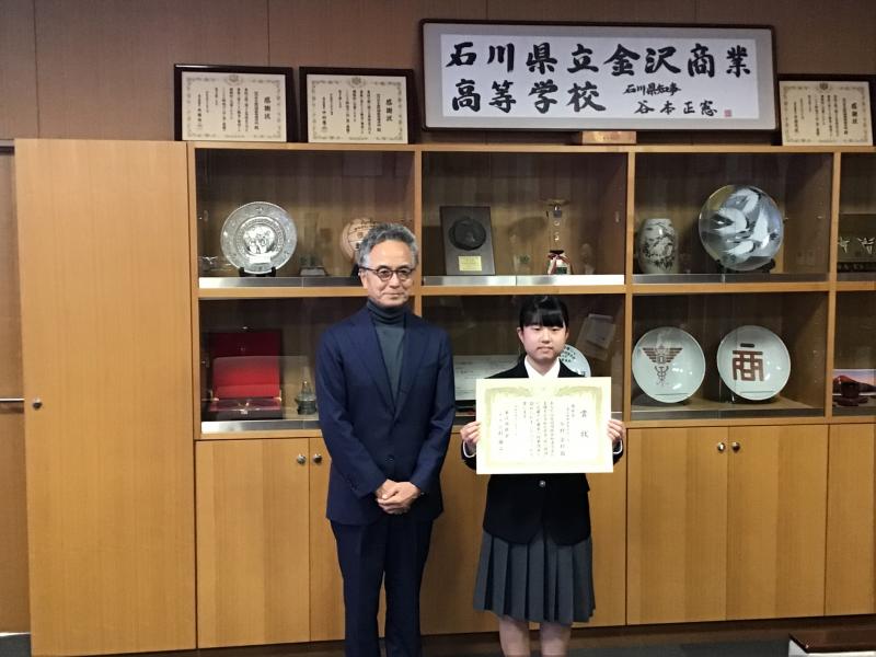 「税の標語」受賞の表彰状を受け取る今村安社さん（１年）